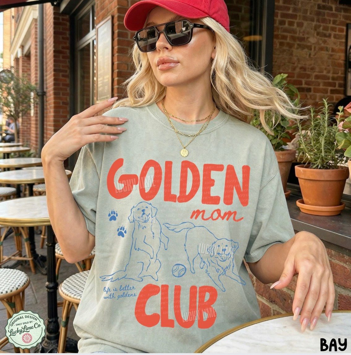 Woman wearing a t-shirt with 'Golden Mom Club' design outdoors.