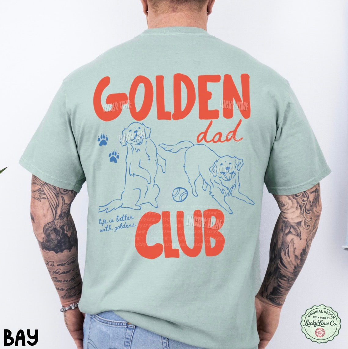 Person wearing a light green t-shirt with 'Golden Dad Club' text and dog illustrations on the back.