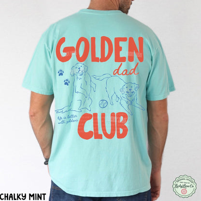 Light blue t-shirt with 'Golden Dad Club' text and dog illustrations on the back, worn by a person.