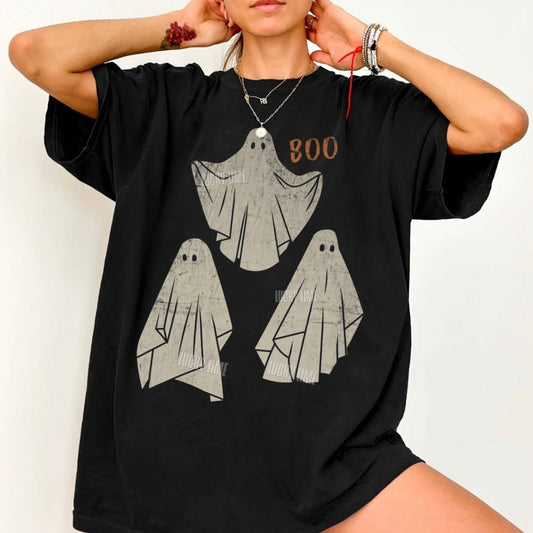 Black t-shirt with ghost design and 'BOO' text worn by a person on a white background