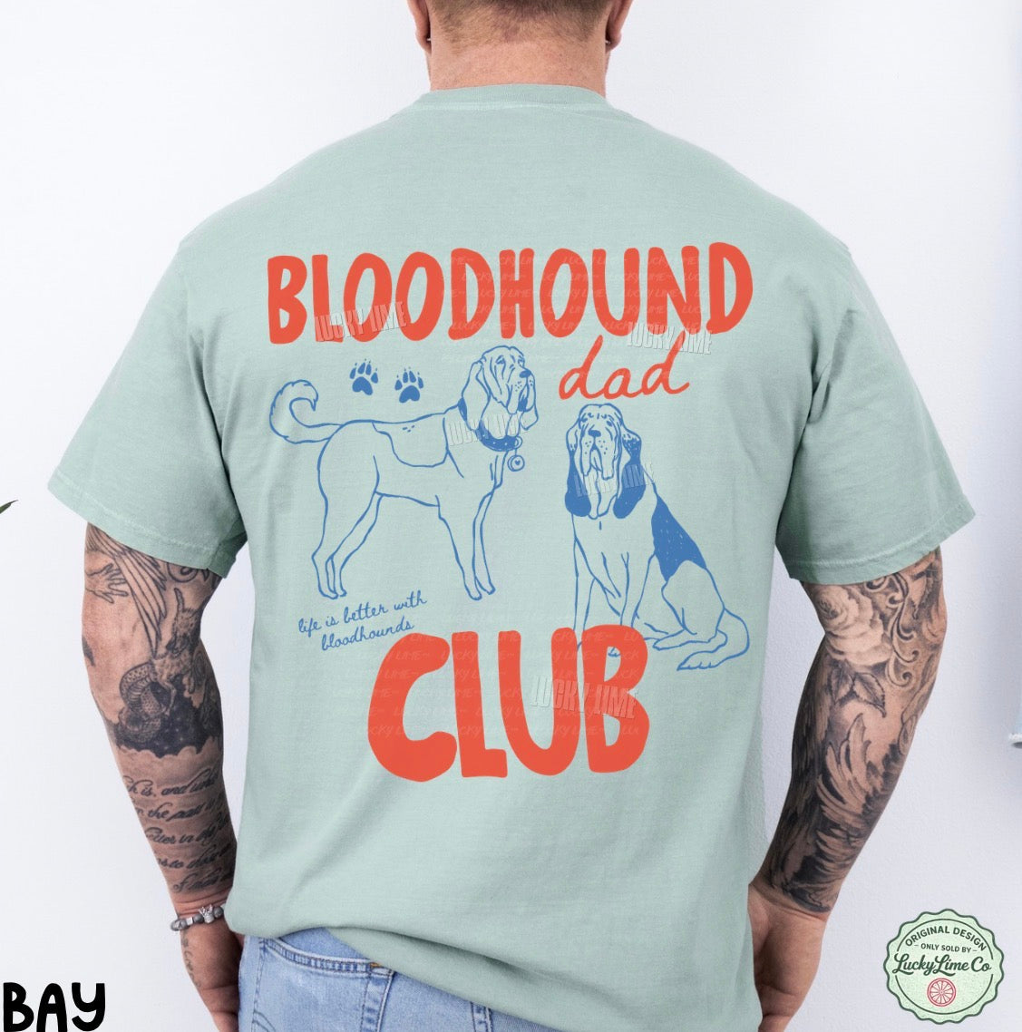 Person wearing a light green t-shirt with 'Bloodhound Dad Club' text and graphics on the back.