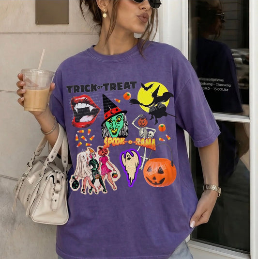Person wearing a purple Halloween-themed t-shirt with graphics, holding a drink and a handbag.