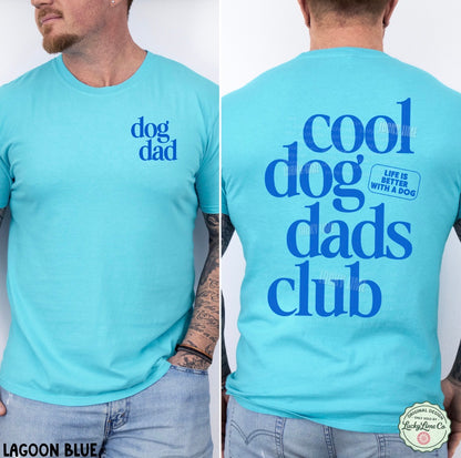 Light blue t-shirt with 'dog dad' text on front and 'cool dog dads club' text on back, worn by a person.