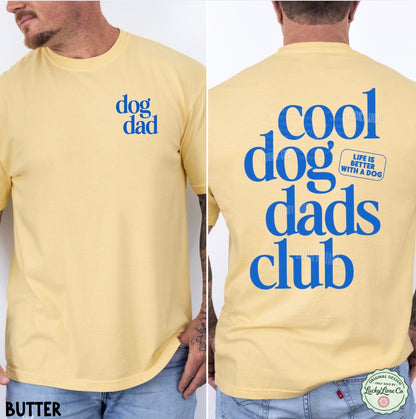 Yellow t-shirt with blue text 'dog dad' on front and 'cool dog dads club' on back, worn by a person.