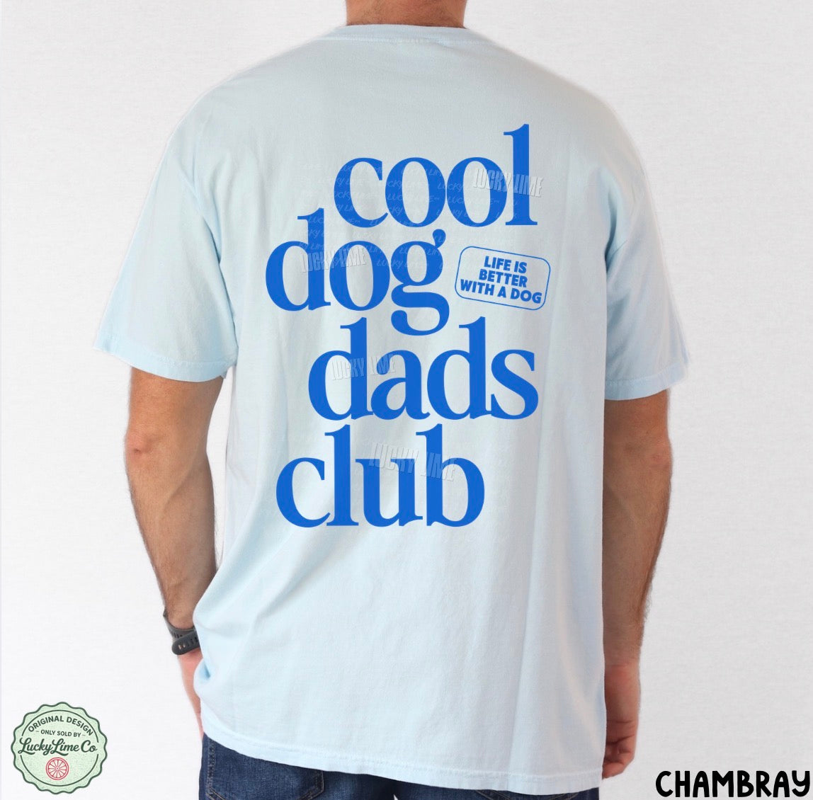 Light blue t-shirt with 'cool dog dads club' text on the back, worn by a person.