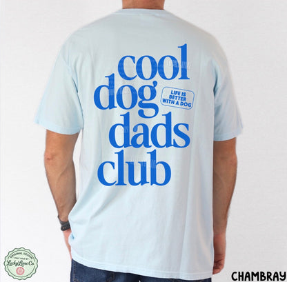 Light blue t-shirt with 'cool dog dads club' text on the back, worn by a person.