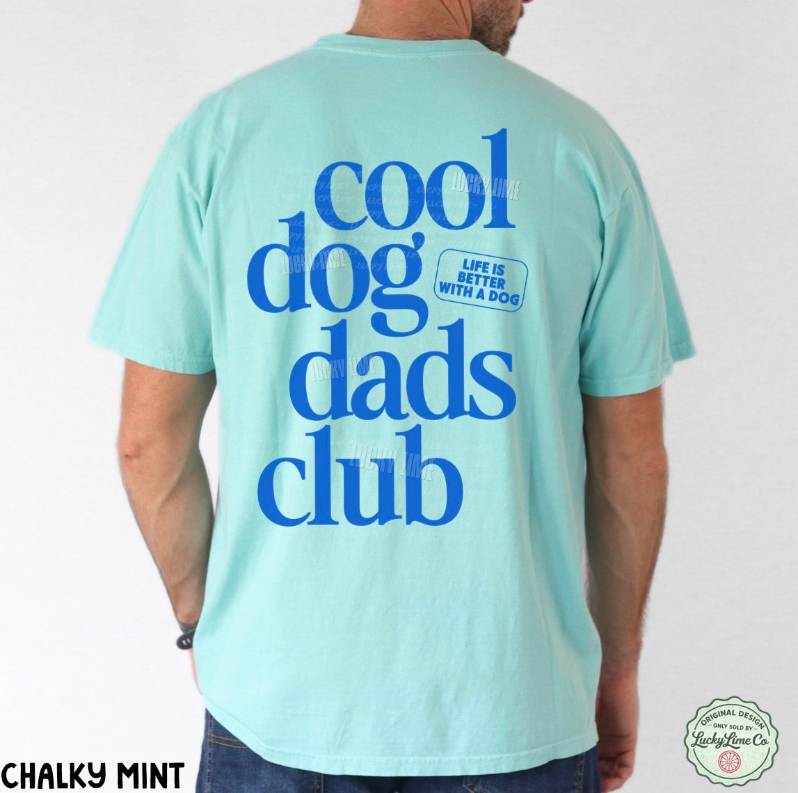 Person wearing a light blue t-shirt with 'cool dog dads club' text on the back.