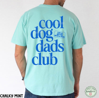 Person wearing a light blue t-shirt with 'cool dog dads club' text on the back.