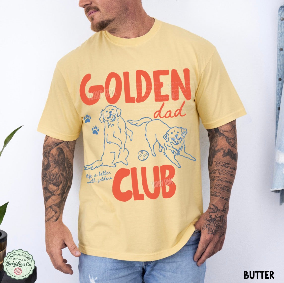 Man wearing a yellow t-shirt with 'Golden Dad Club' design and tattoos on arms.