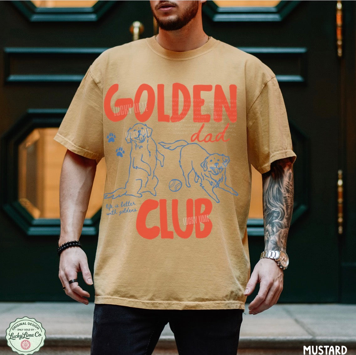 Man wearing a tan t-shirt with 'Golden Dad Club' text and graphics in front of a dark door.
