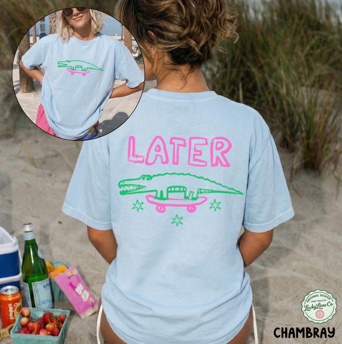 Person wearing a light blue t-shirt with a graphic design and 'LATER' text on a beach.