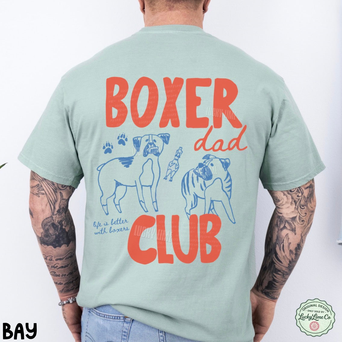Person wearing a light green t-shirt with 'Boxer Dad Club' text and graphics on the back.