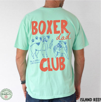Light green t-shirt with 'Boxer Dad Club' text and dog illustrations on a plain background