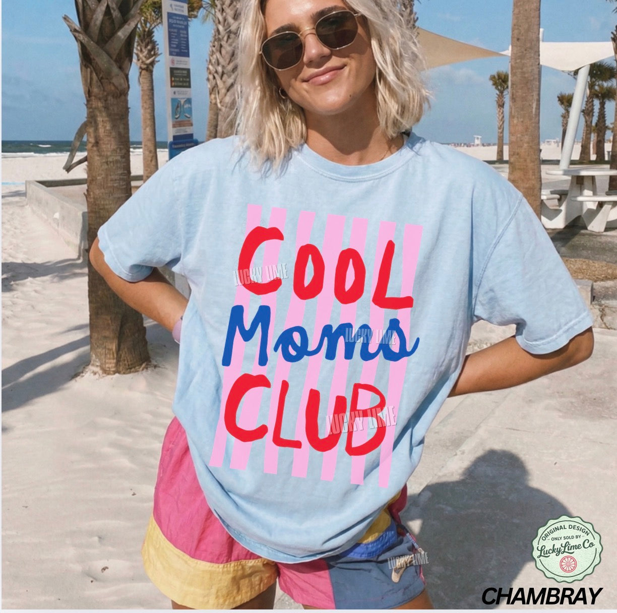 Person wearing a 'Cool Moms Club' t-shirt on a beach