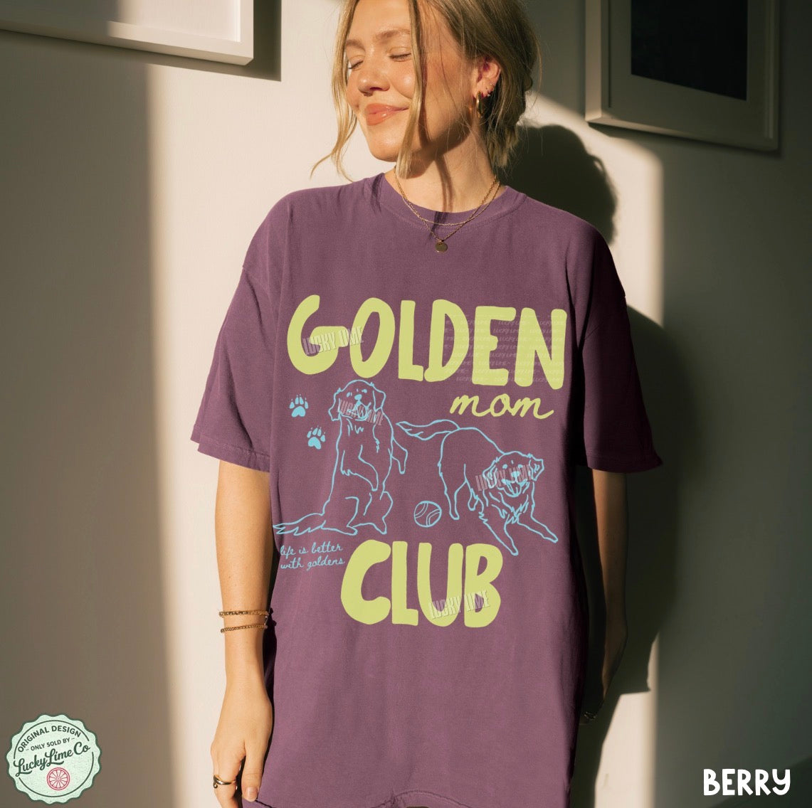 Person wearing a purple t-shirt with 'Golden Mom Club' text and graphics.