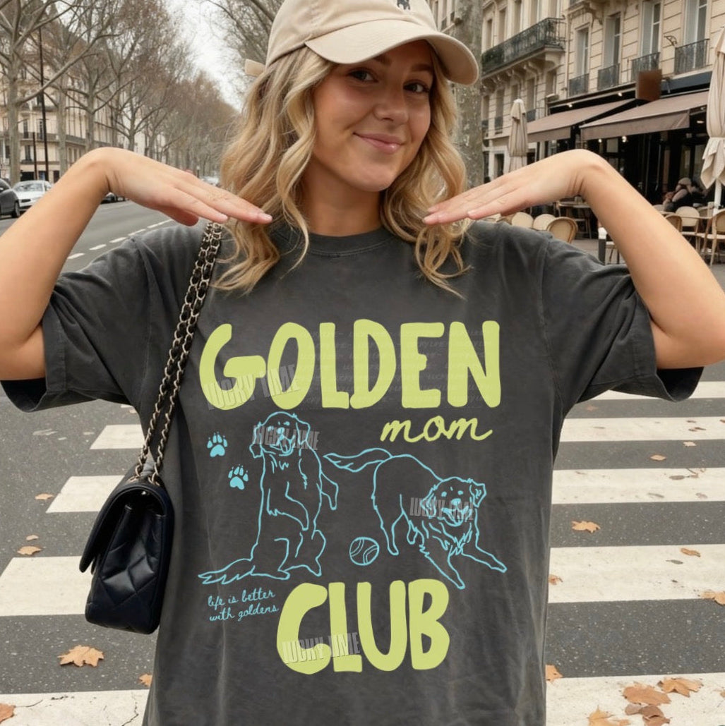 Woman wearing a t-shirt with 'Golden Mom Club' design on a street.