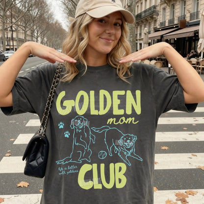 Woman wearing a t-shirt with 'Golden Mom Club' design on a street.