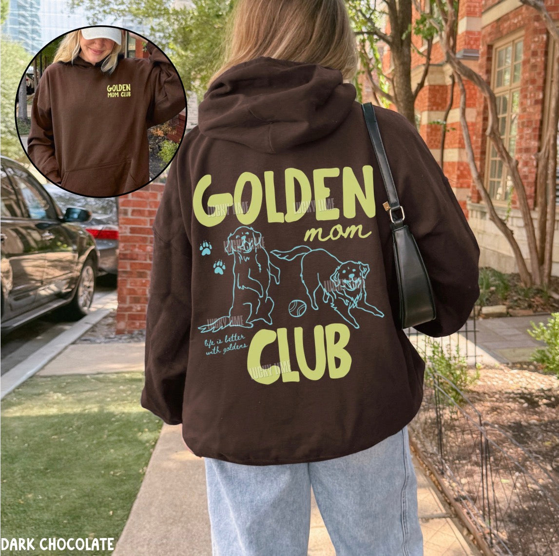 Person wearing a brown hoodie with 'GOLDEN mom CLUB' text and dog illustrations, outdoors.