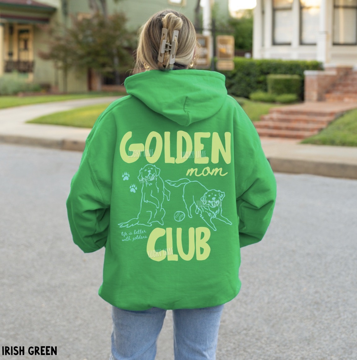 Person wearing a green hoodie with 'Golden Mom Club' text and graphic on the back.