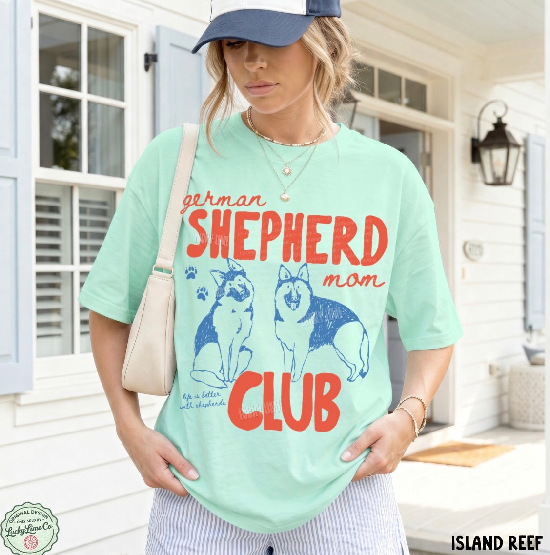 Woman wearing a light green t-shirt with 'German Shepherd mom club' design outdoors.