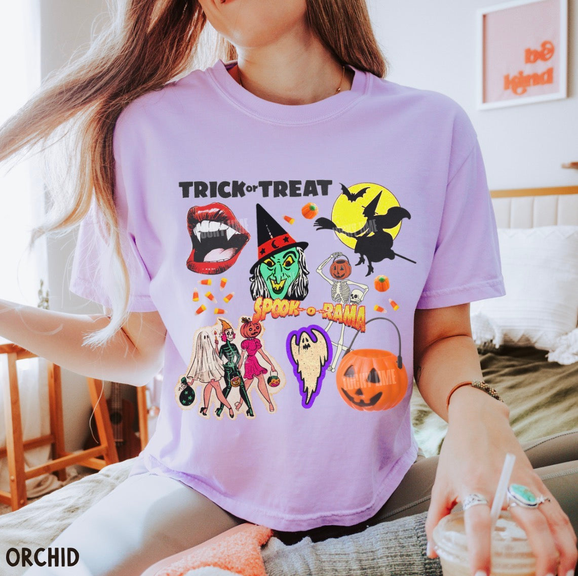 Person wearing a purple Halloween-themed t-shirt with various graphics.