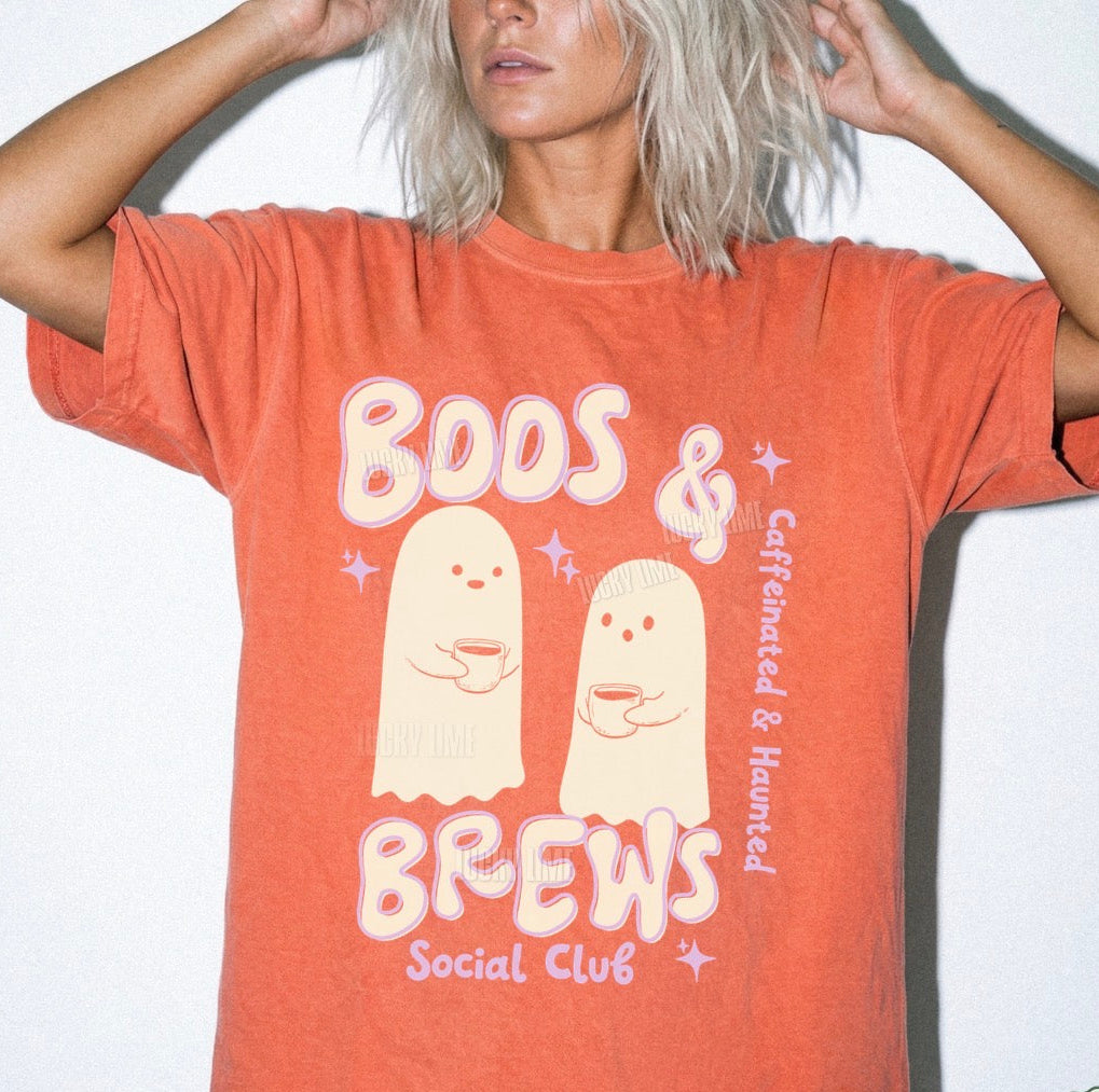 Person wearing a bright salmon-colored t-shirt with ghost graphics and text on a white background