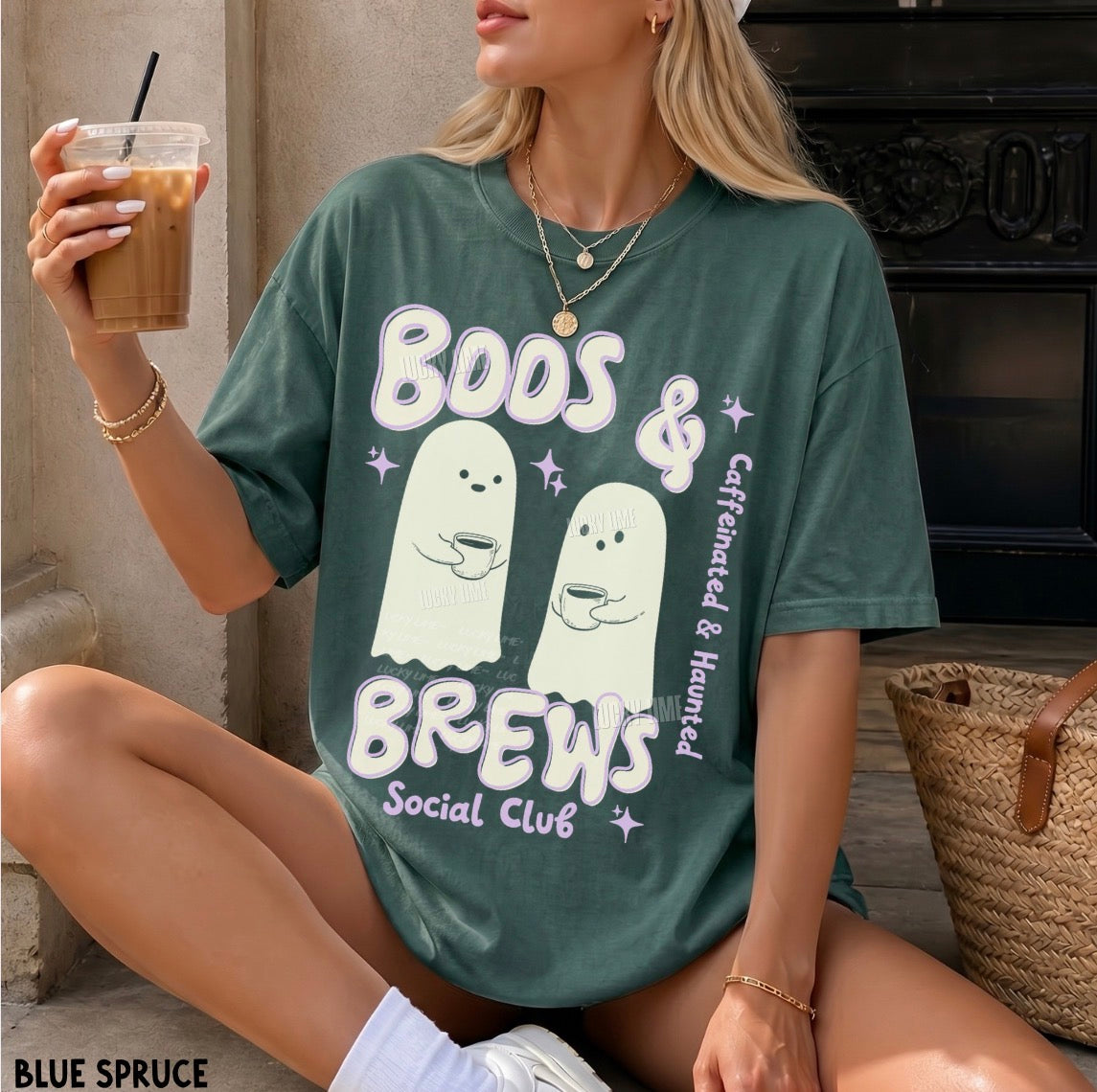 Person wearing a green t-shirt with 'Boos & Brews Social Club' design, sitting on the floor.