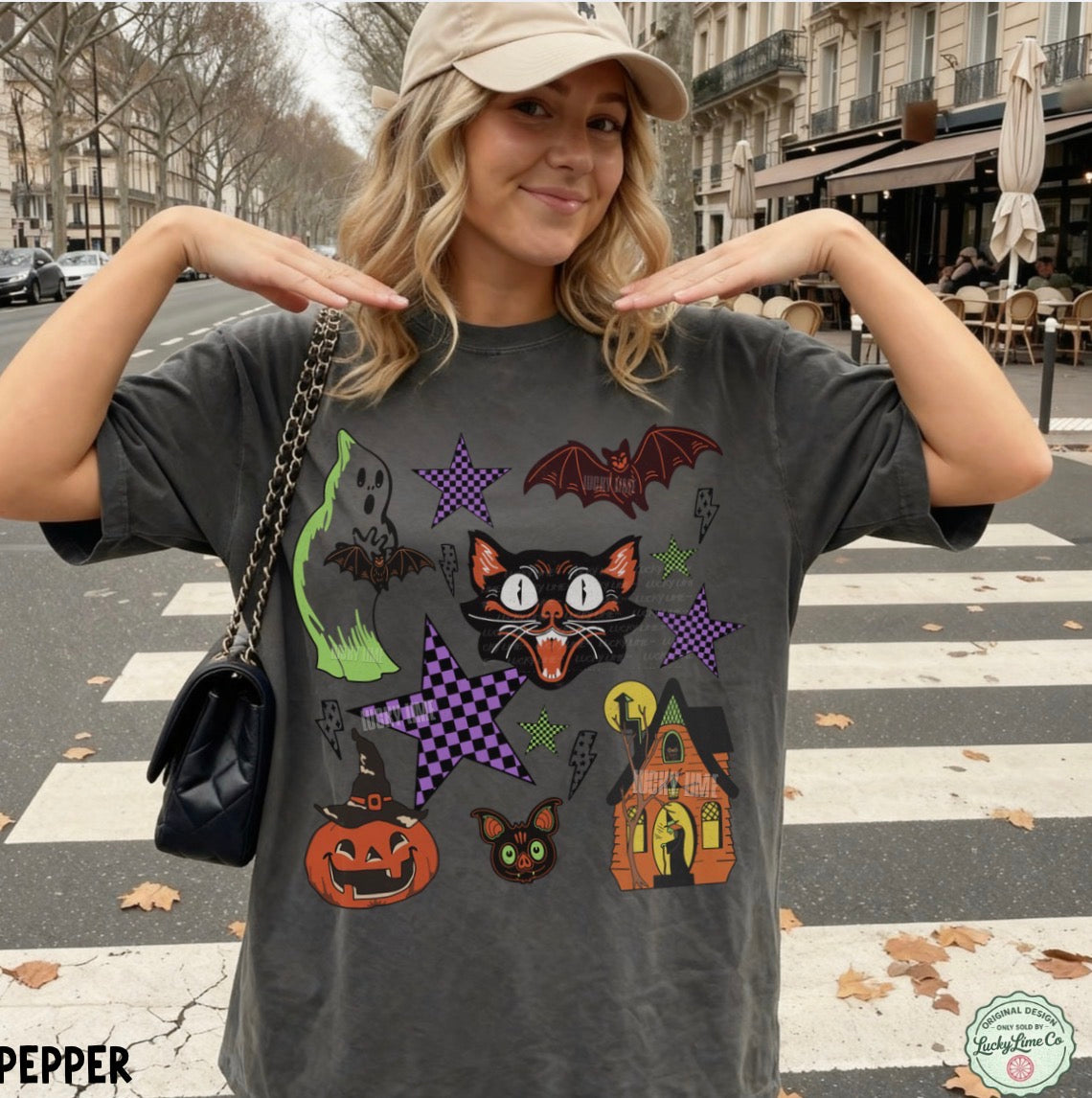 Woman wearing a Halloween-themed t-shirt with various graphics on a city street.