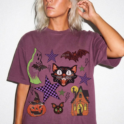 Person wearing a purple t-shirt with Halloween-themed graphics on a white background