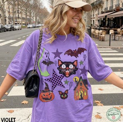 Woman wearing a purple Halloween-themed t-shirt on a city street.