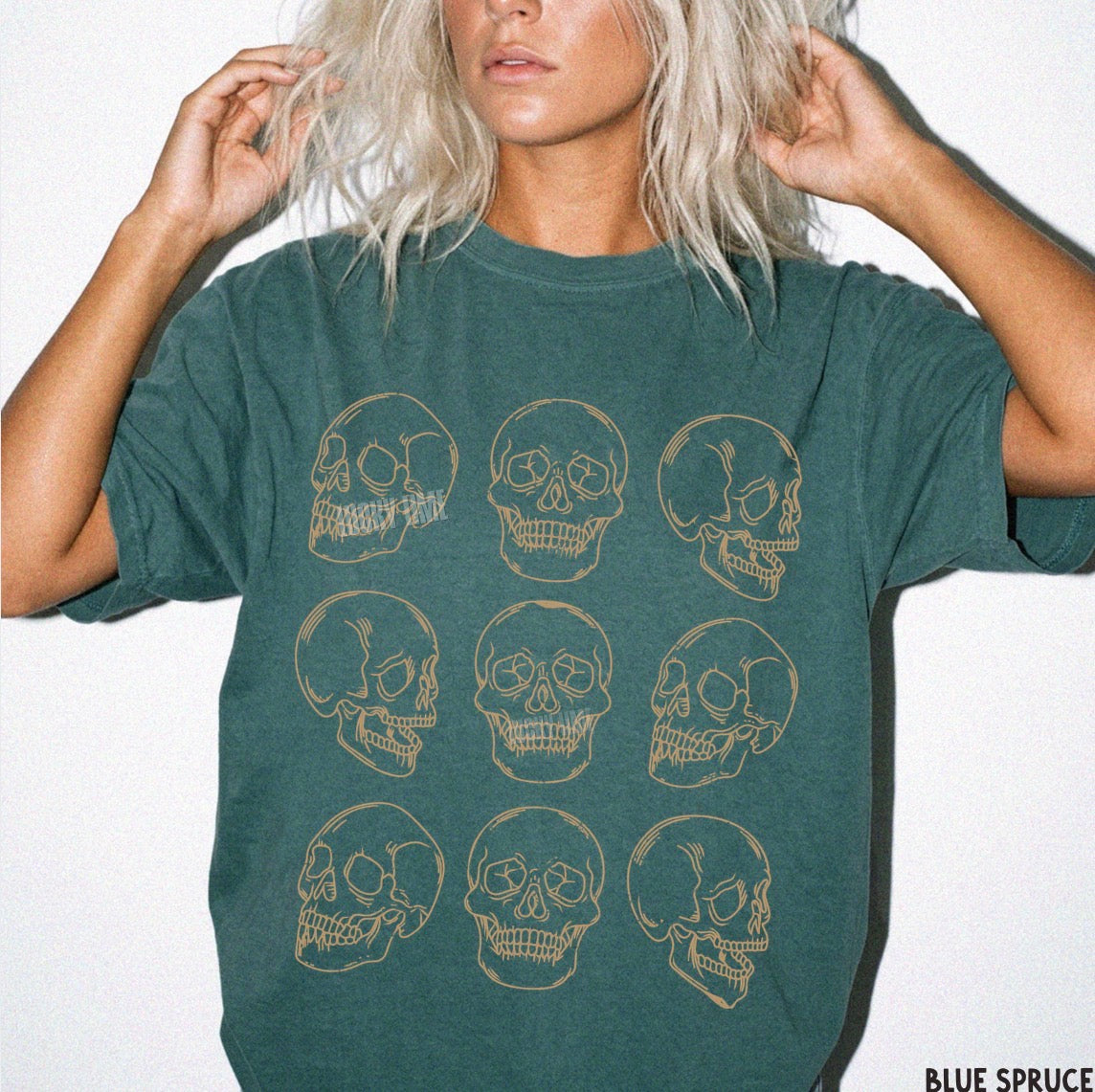 Person wearing a green t-shirt with skull designs on a white background