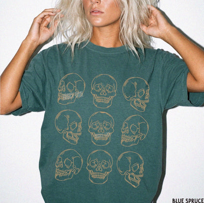 Person wearing a green t-shirt with skull designs on a white background