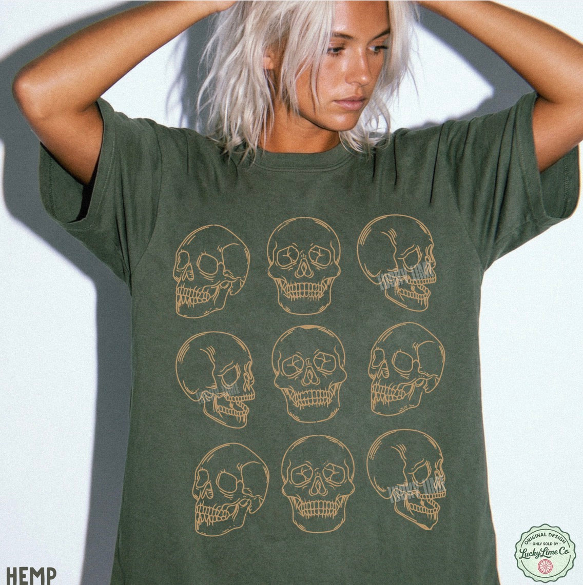 Person wearing a green t-shirt with skull designs on a white background