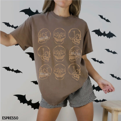Person wearing a brown t-shirt with skull designs and checkered shorts against a wall with bats.