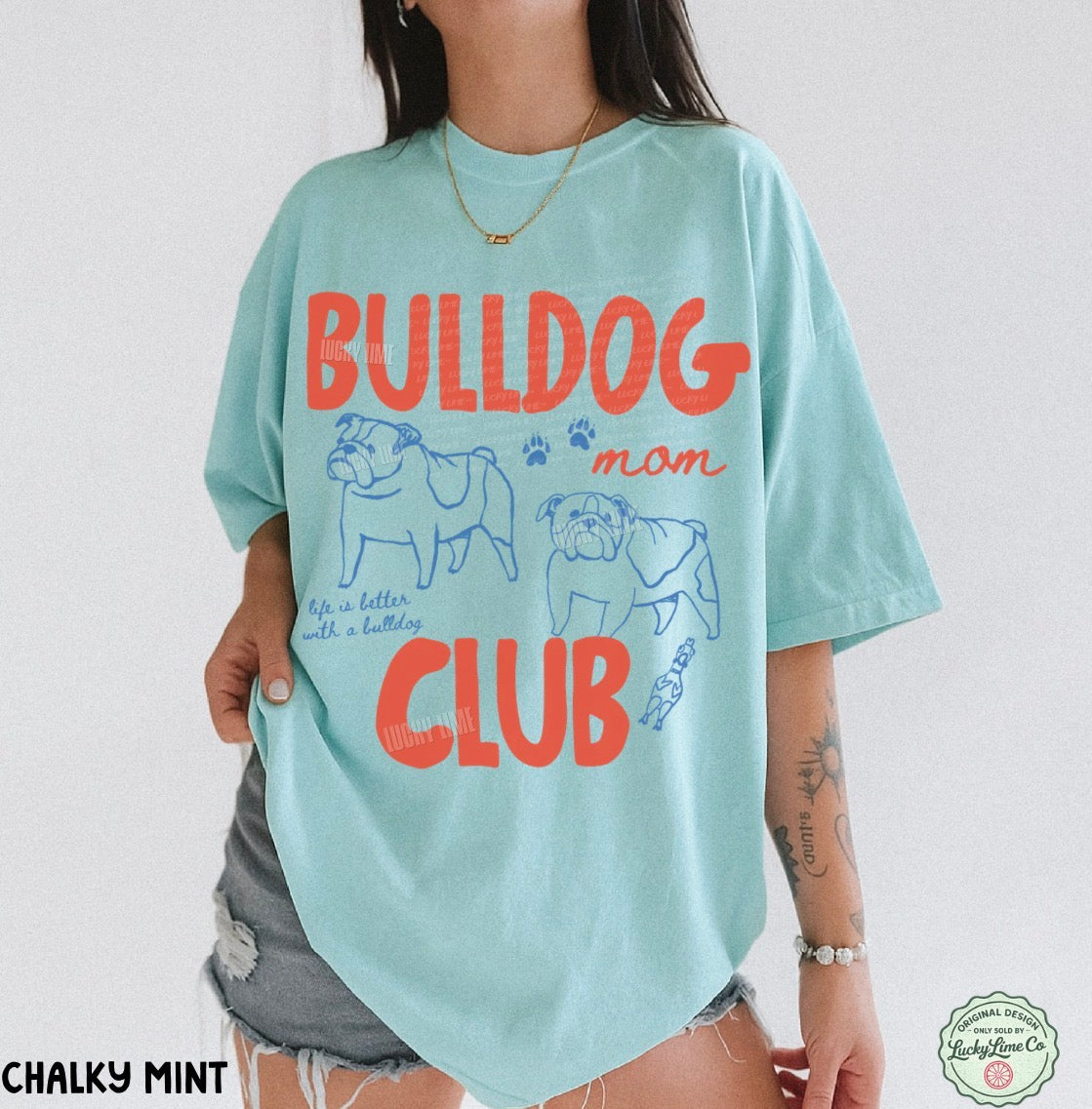 Person wearing a light blue t-shirt with 'Bulldog Man Club' text and graphics on a white background