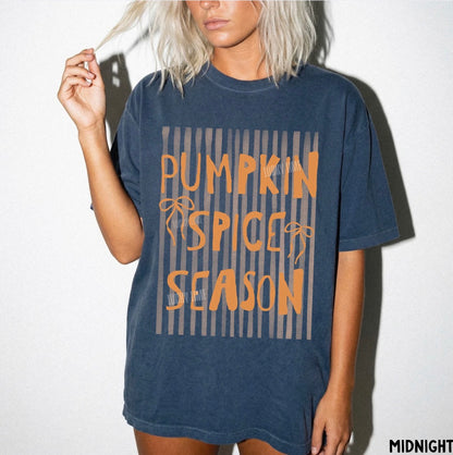 Person wearing a blue t-shirt with 'Pumpkin Spice Season' text on a white background