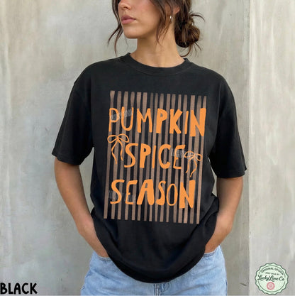 Person wearing a black t-shirt with 'Pumpkin Spice Season' text against a light gray background