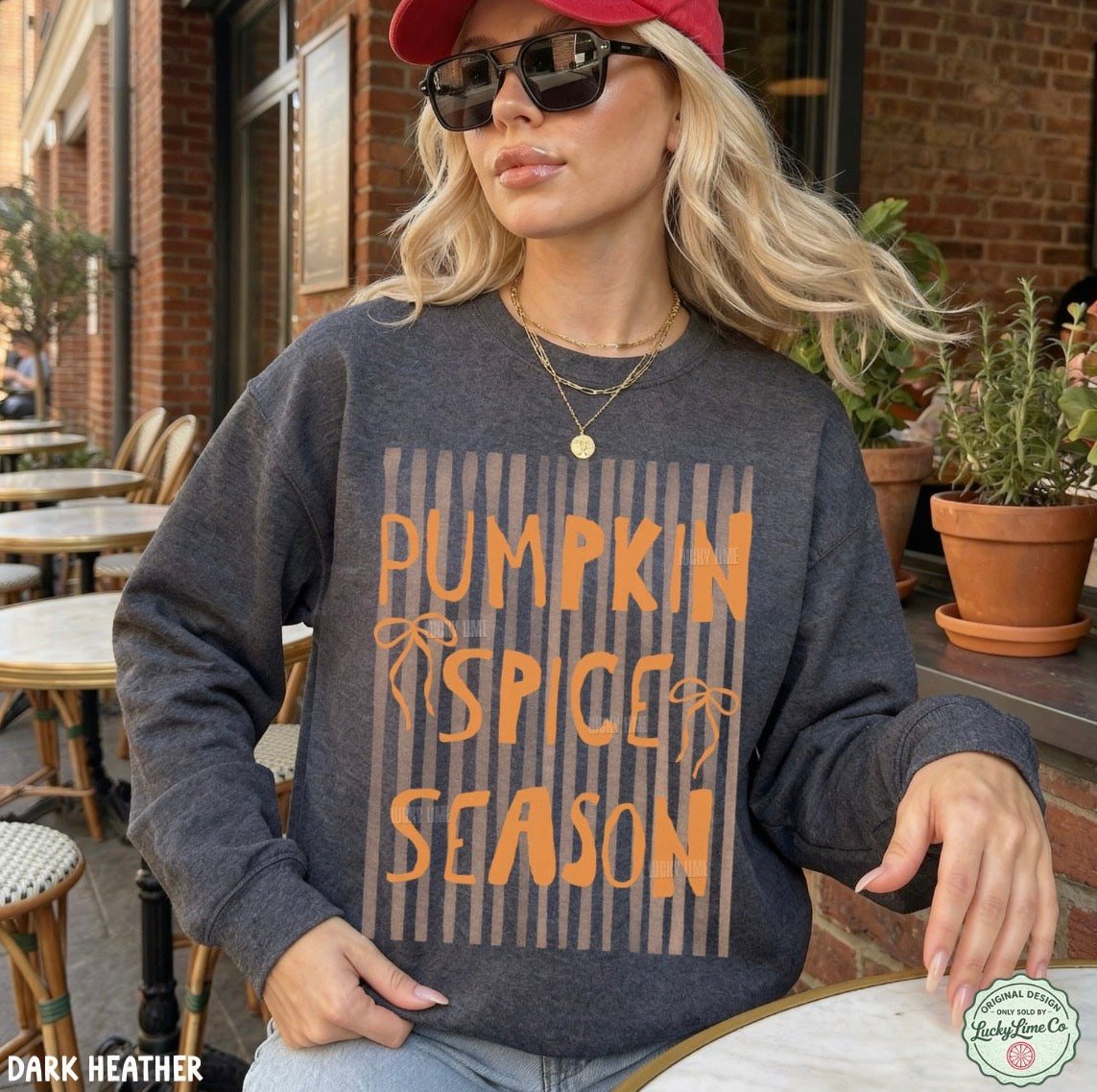 Woman wearing a 'Pumpkin Spice Season' sweater outdoors.