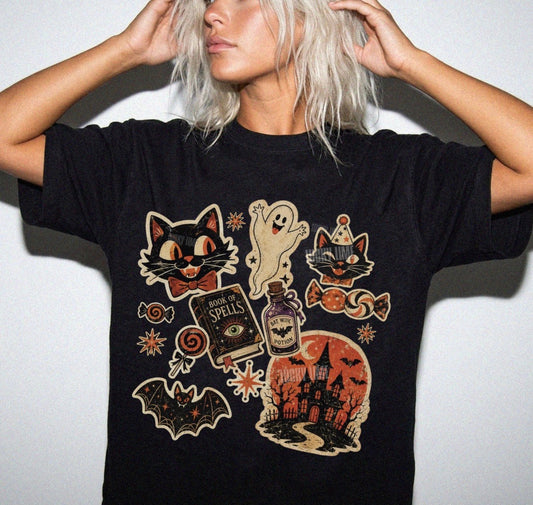 Person wearing a black t-shirt with Halloween-themed graphics on a plain background
