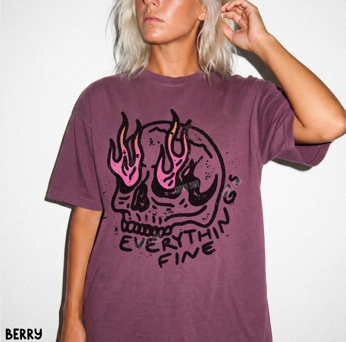 Person wearing a purple t-shirt with a graphic design and text on a white background