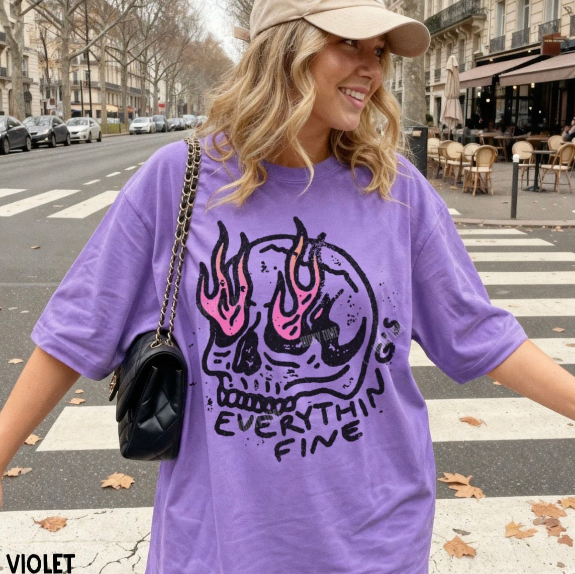 Woman wearing a purple t-shirt with a graphic design and text, standing on a street.