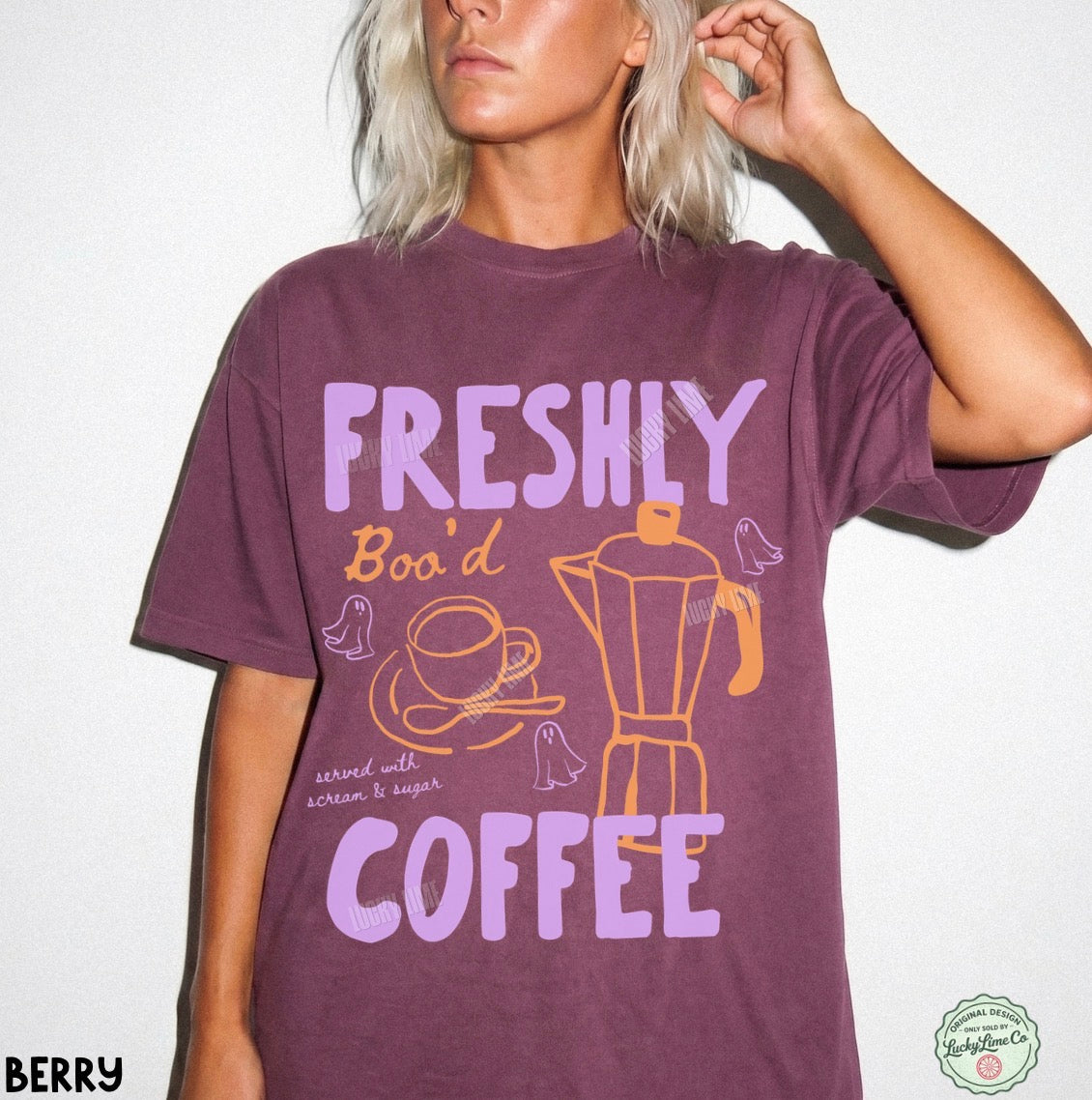 Person wearing a purple t-shirt with coffee-themed graphics and text.