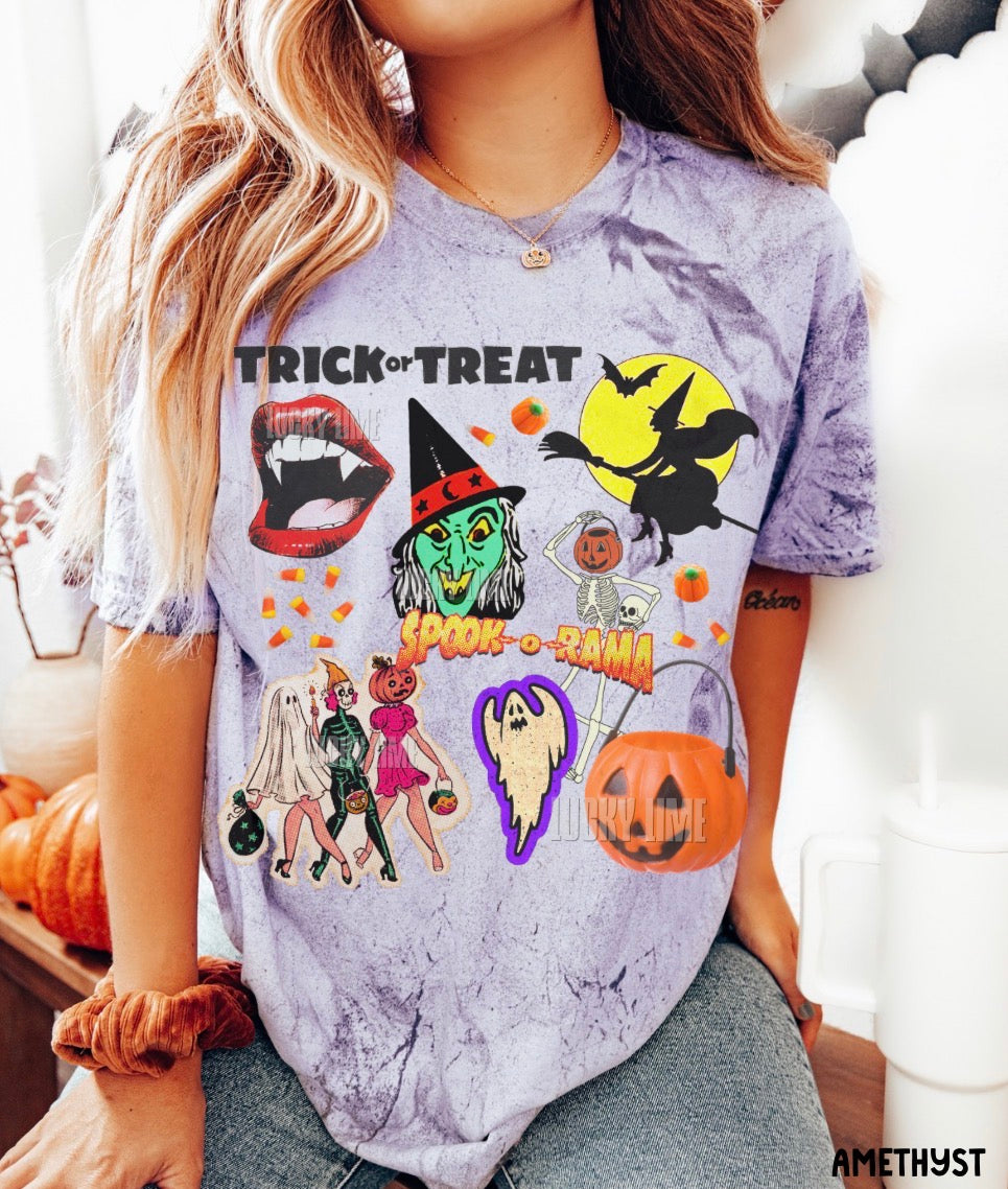 A woman wearing a lavender-purple tie-dye t-shirt with a colorful Halloween graphic print that reads 'TRICK or TREAT'