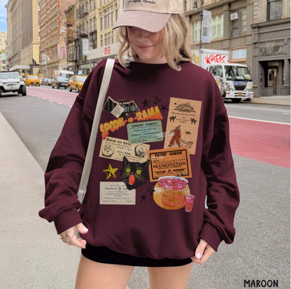A woman wearing a maroon sweatshirt with a vintage concert poster collage graphic, standing on a city street.
