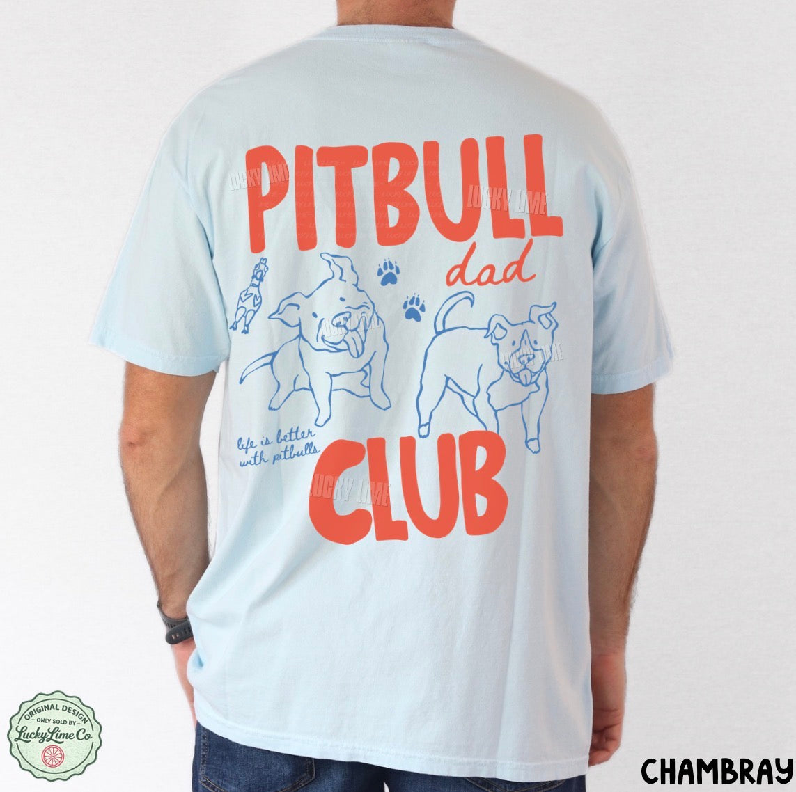 A man wearing a light blue t-shirt, viewed from the back. The shirt features a graphic print with the words 'PITBULL dad CLUB' in red and blue, along with illustrations of two pitbull dogs and paw prints.