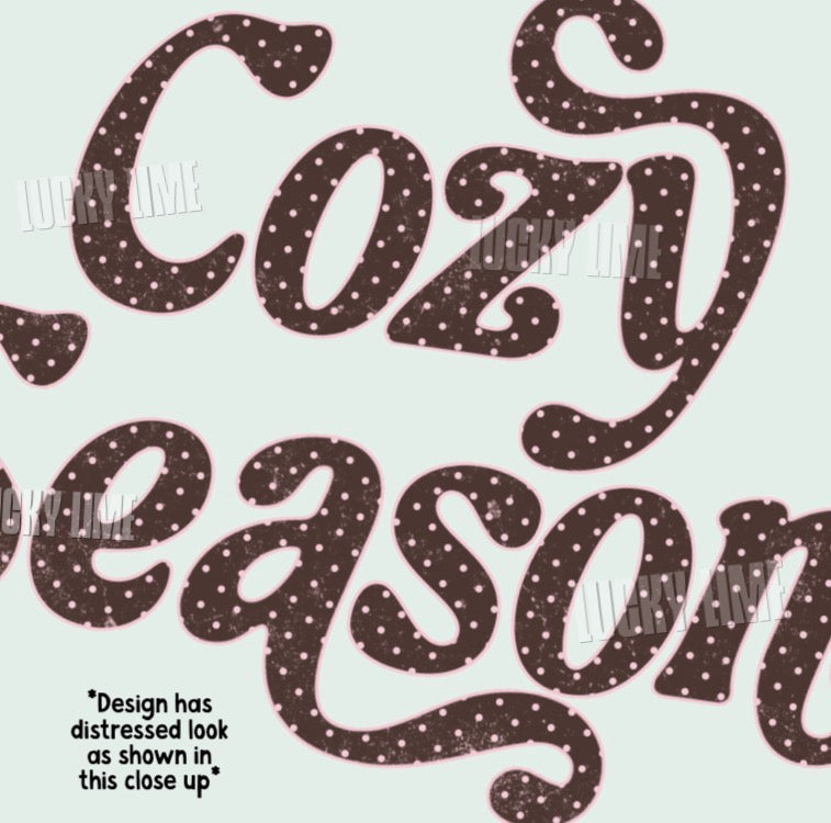 A close-up of decorative lettering reading 'Cozy Season' in dark brown with small white polka dots, on a pale mint background. Faint 'Lucky Lime' watermarks are visible, and a note says the design has a distressed look as shown in this close-up.