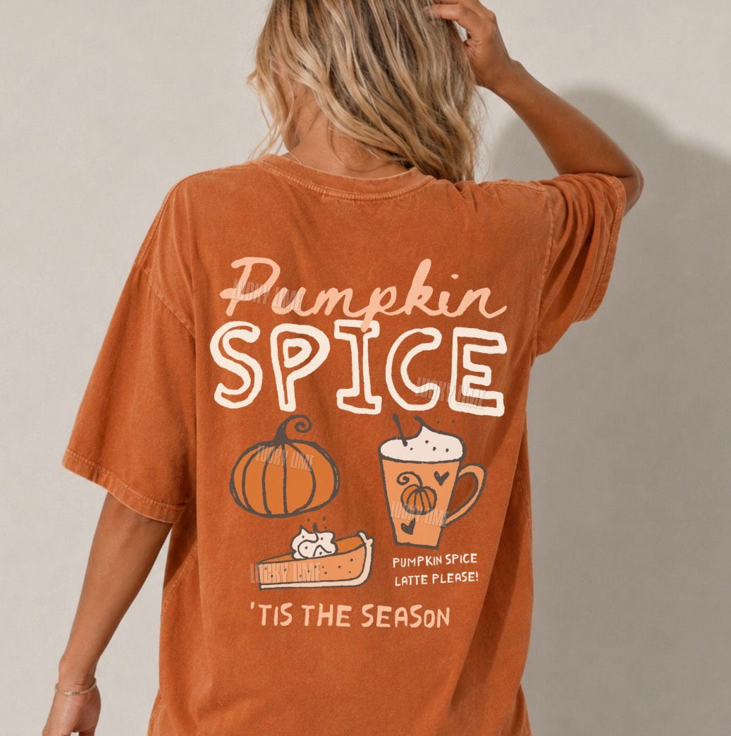 A woman shown from the back wearing an oversized burnt orange graphic T-shirt with 'Pumpkin Spice' text and fall-themed illustrations including a pumpkin, latte, and cookie on a plain light beige background.