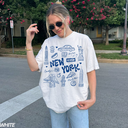 Person wearing a white t-shirt with 'New York' design outdoors.